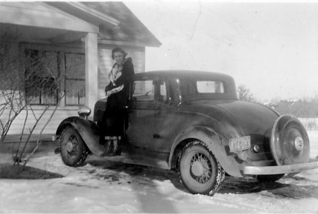 Minerva Johnston by her 1925 Plymouth automobile.